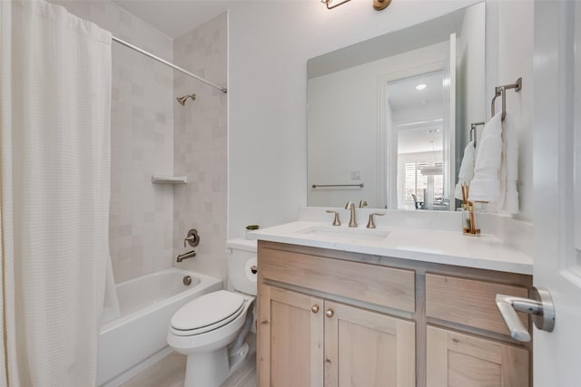 full bath with vanity, shower / tub combo, and toilet