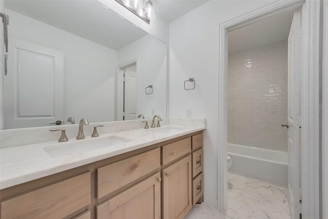 full bath with a sink, toilet, marble finish floor, and double vanity