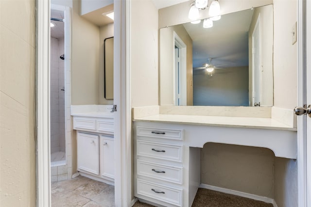 full bathroom featuring a tile shower, tile patterned flooring, vanity, and a ceiling fan