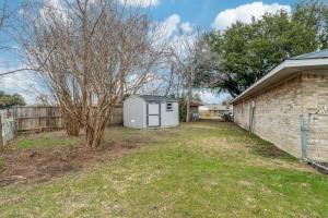 view of yard featuring a fenced backyard, a storage shed, and an outdoor structure