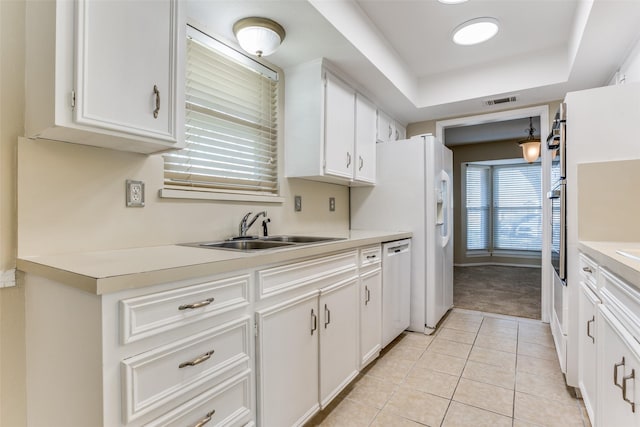 kitchen featuring a sink, visible vents, dishwasher, and white cabinetry