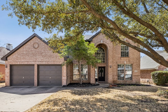 traditional home with an attached garage, brick siding, and driveway