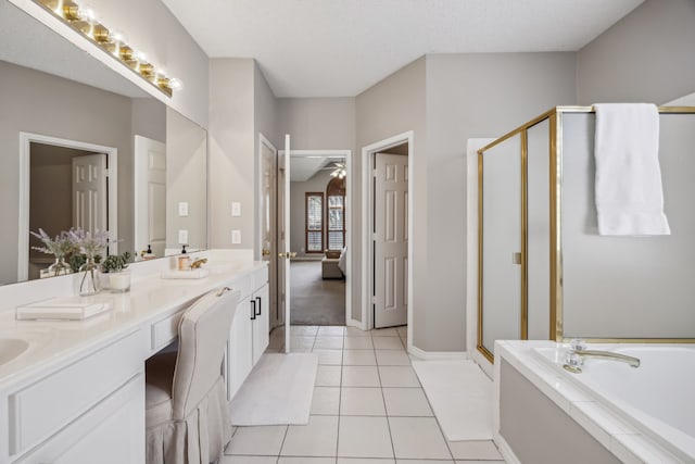 bathroom with ceiling fan, double vanity, a stall shower, a bath, and tile patterned floors