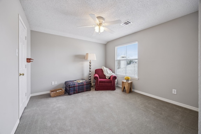 sitting room with visible vents, baseboards, ceiling fan, and carpet flooring