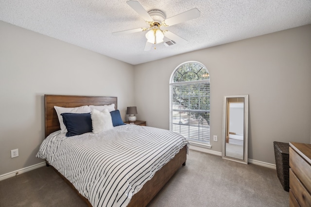 bedroom featuring baseboards, carpet floors, a textured ceiling, and ceiling fan