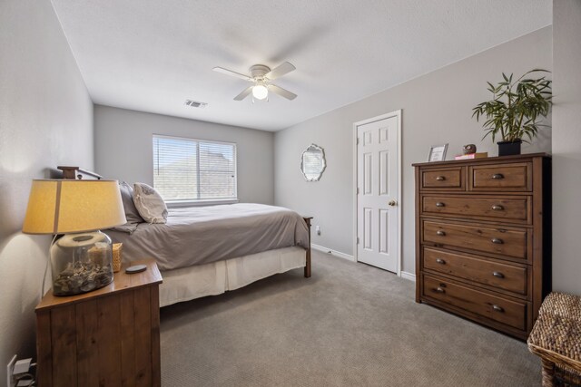 bedroom with visible vents, a ceiling fan, baseboards, and carpet floors