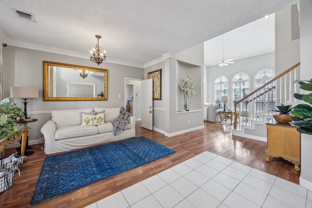 living area with stairway, wood finished floors, and ornamental molding