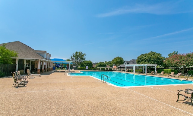 pool featuring a patio, fence, and a pergola