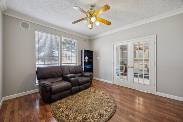 living area with crown molding, wood finished floors, french doors, and ceiling fan