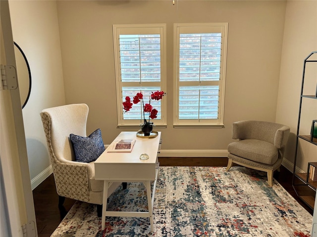 office space with dark wood finished floors, plenty of natural light, and baseboards