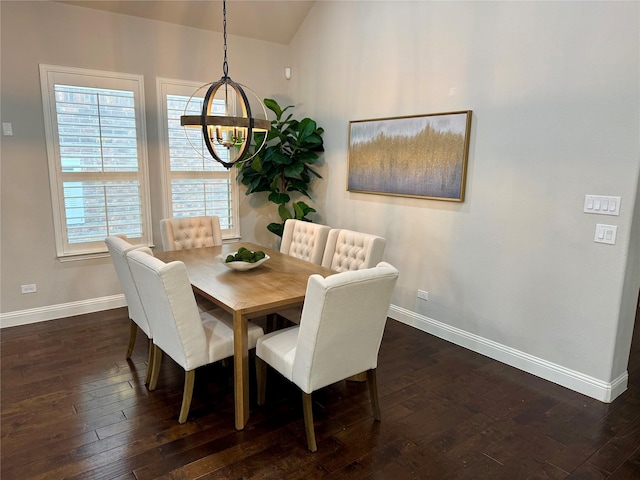 dining area with dark wood-style floors, baseboards, and a chandelier