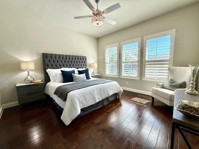 bedroom with baseboards, wood-type flooring, and ceiling fan