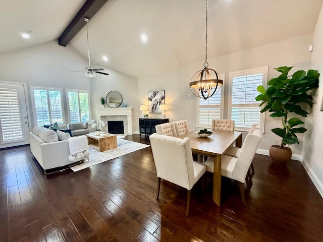 dining area featuring beam ceiling, a healthy amount of sunlight, high vaulted ceiling, and dark wood-type flooring