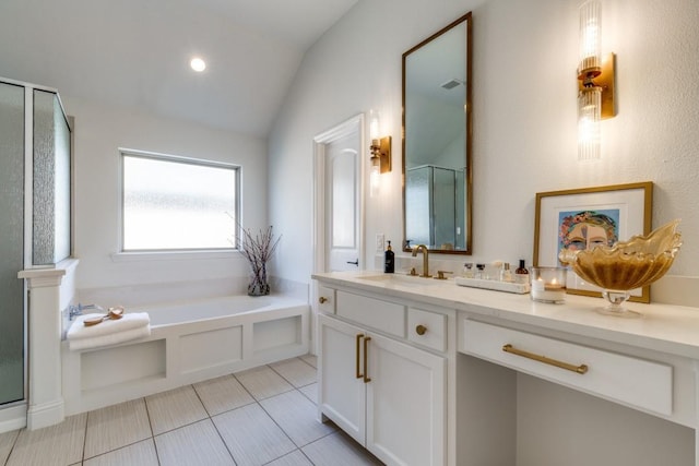 bathroom featuring vanity, lofted ceiling, tile patterned flooring, a shower stall, and a bath