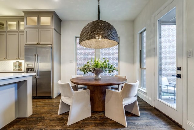 unfurnished dining area featuring dark wood finished floors