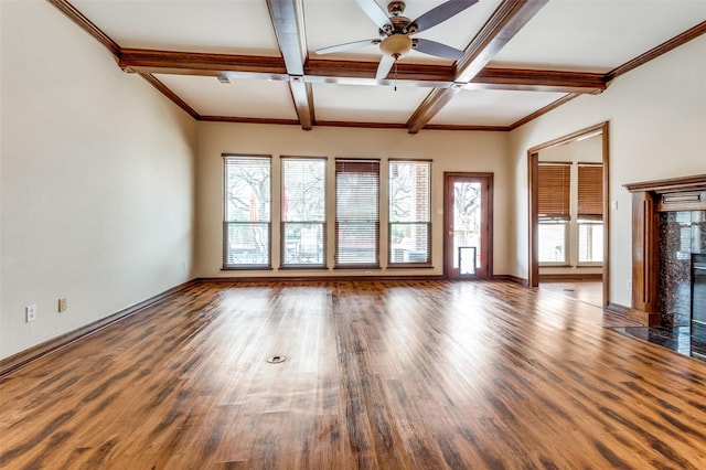 unfurnished living room featuring a high end fireplace, baseboards, beam ceiling, wood finished floors, and a ceiling fan