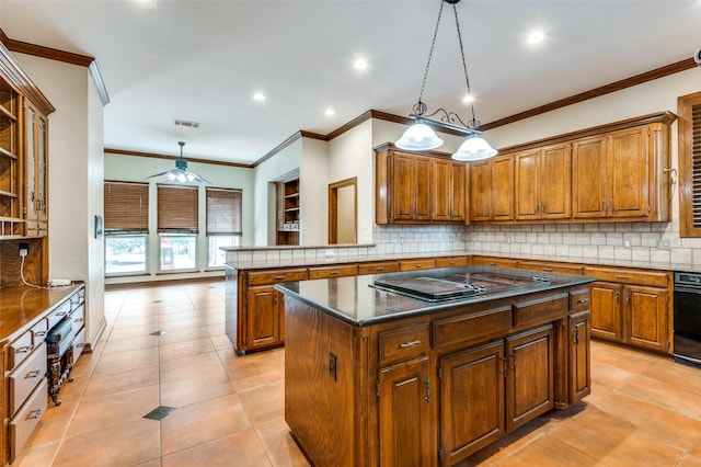 kitchen featuring brown cabinets, a kitchen island, electric stovetop, decorative light fixtures, and tasteful backsplash