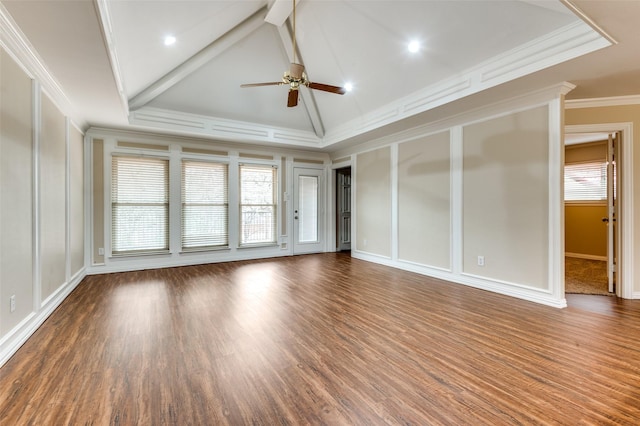 spare room with a ceiling fan, wood finished floors, crown molding, a decorative wall, and vaulted ceiling