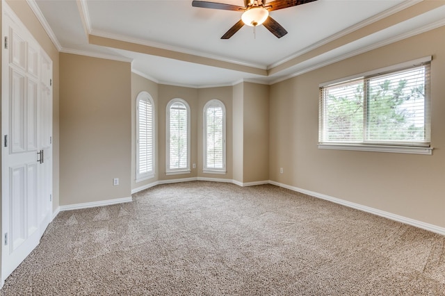 empty room featuring carpet, baseboards, a wealth of natural light, and ceiling fan