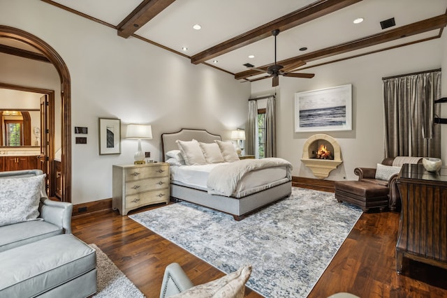 bedroom with baseboards, beam ceiling, wood-type flooring, and crown molding