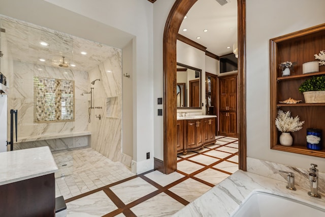 full bathroom featuring recessed lighting, a marble finish shower, baseboards, and vanity