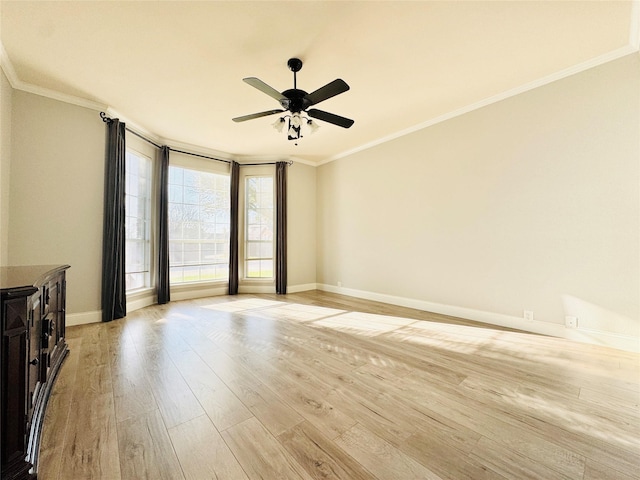 unfurnished room featuring baseboards, a ceiling fan, light wood-type flooring, and ornamental molding