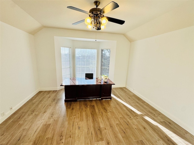 office with vaulted ceiling, light wood-style flooring, a ceiling fan, and baseboards