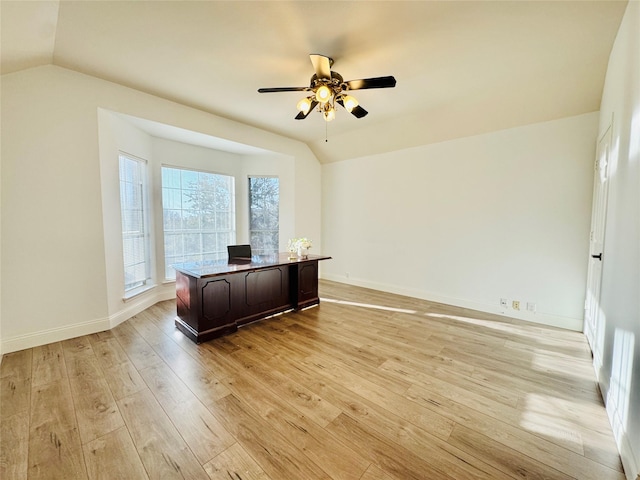 office with vaulted ceiling, a ceiling fan, light wood-type flooring, and baseboards