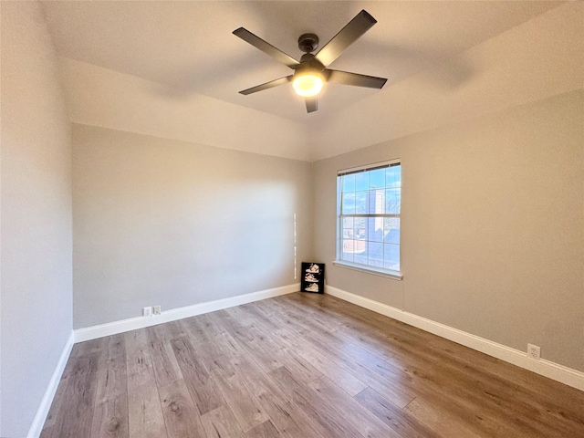 unfurnished room featuring wood finished floors, baseboards, and ceiling fan