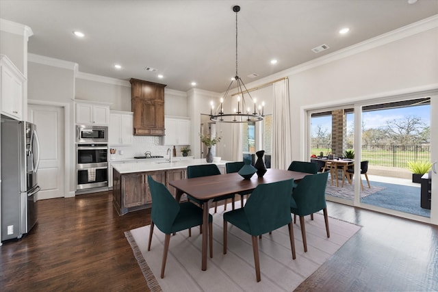 dining space with visible vents, recessed lighting, dark wood-style flooring, ornamental molding, and a chandelier