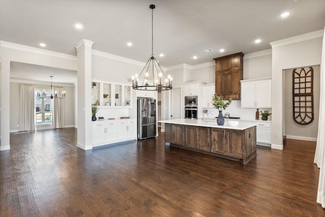 kitchen with dark wood-style floors, a notable chandelier, appliances with stainless steel finishes, and light countertops