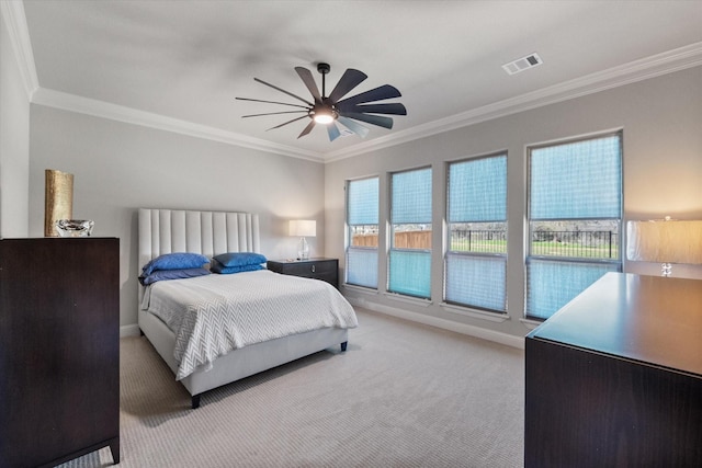 bedroom with visible vents, baseboards, light colored carpet, and crown molding