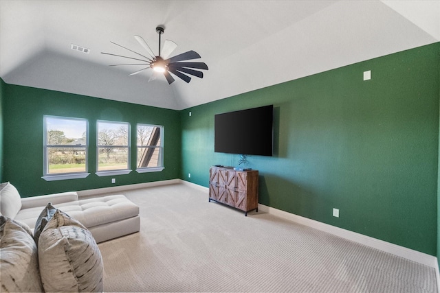 carpeted living area with visible vents, baseboards, lofted ceiling, and a ceiling fan