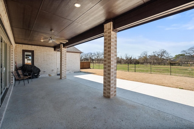 view of patio with grilling area, a ceiling fan, and fence