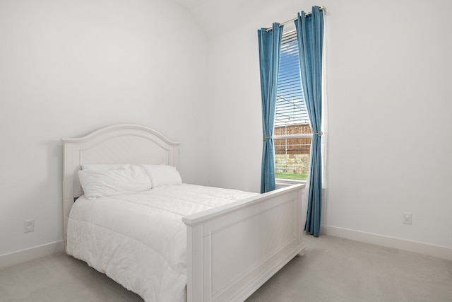 bedroom with light carpet and baseboards