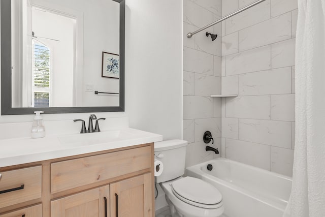 full bathroom with vanity, shower / tub combo, and toilet