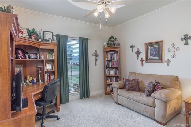 carpeted office space with a ceiling fan, baseboards, and ornamental molding