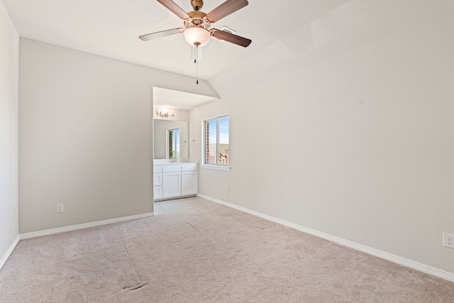 unfurnished room with baseboards, light carpet, ceiling fan, and vaulted ceiling