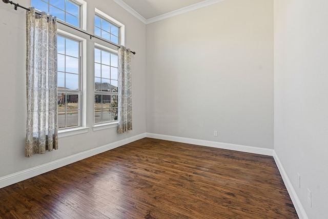 unfurnished room featuring baseboards, ornamental molding, and dark wood-style flooring