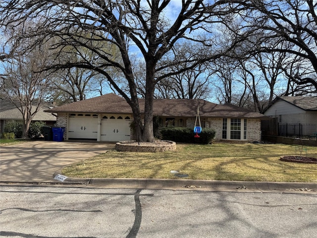 ranch-style house featuring brick siding, fence, concrete driveway, a front yard, and a garage