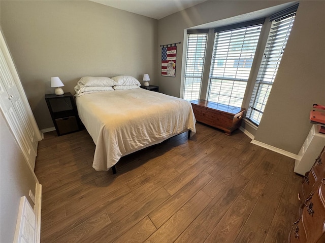 bedroom featuring baseboards and wood finished floors