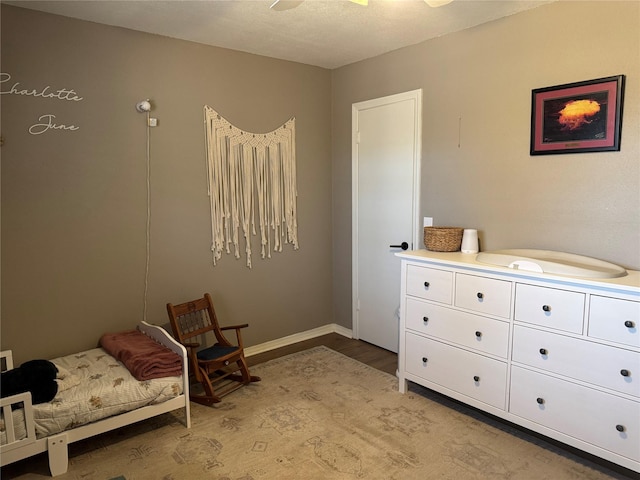 bedroom with light wood-type flooring and baseboards