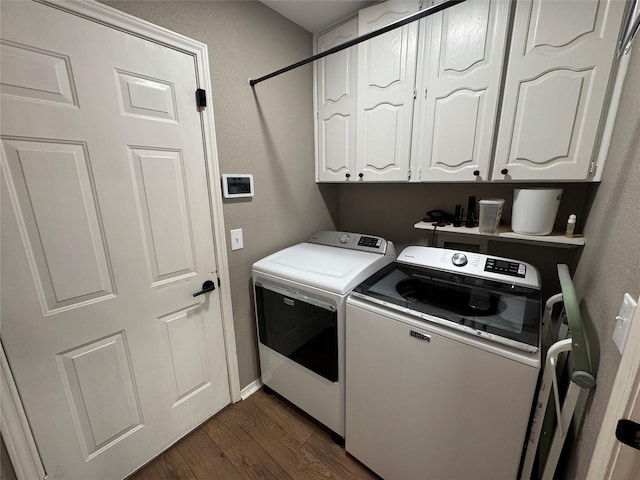 washroom featuring dark wood finished floors, cabinet space, and washing machine and dryer