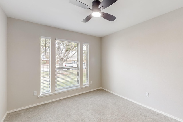 unfurnished room featuring baseboards, carpet, and ceiling fan