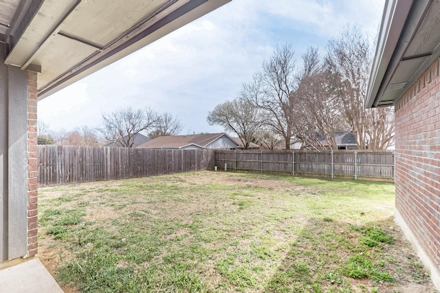 view of yard with a fenced backyard