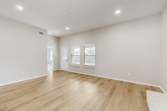 empty room with light wood-type flooring, visible vents, and recessed lighting