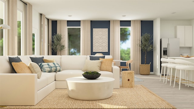 living room with light wood-style flooring and a wealth of natural light