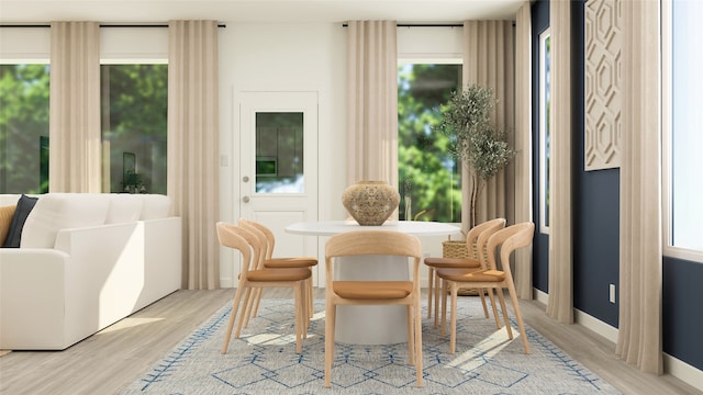 dining area featuring baseboards and light wood-style floors