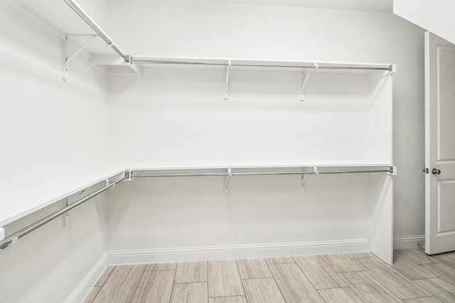 walk in closet featuring wood tiled floor