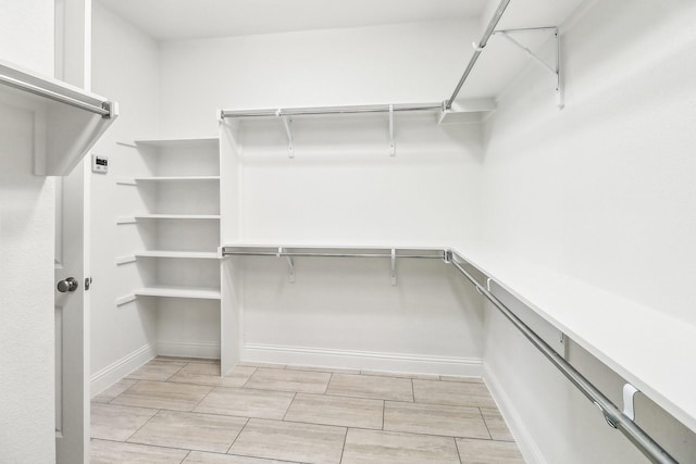 carpeted spare room with a ceiling fan, baseboards, and a sink